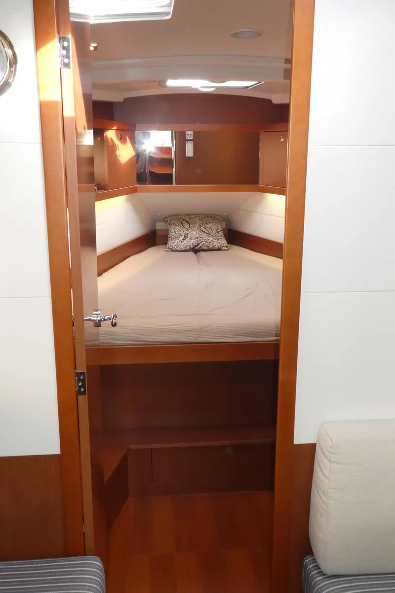 Slide: The Image of 2014 Beneteau Oceanis 41 cabin interior with cozy bed and wooden finish. - 37