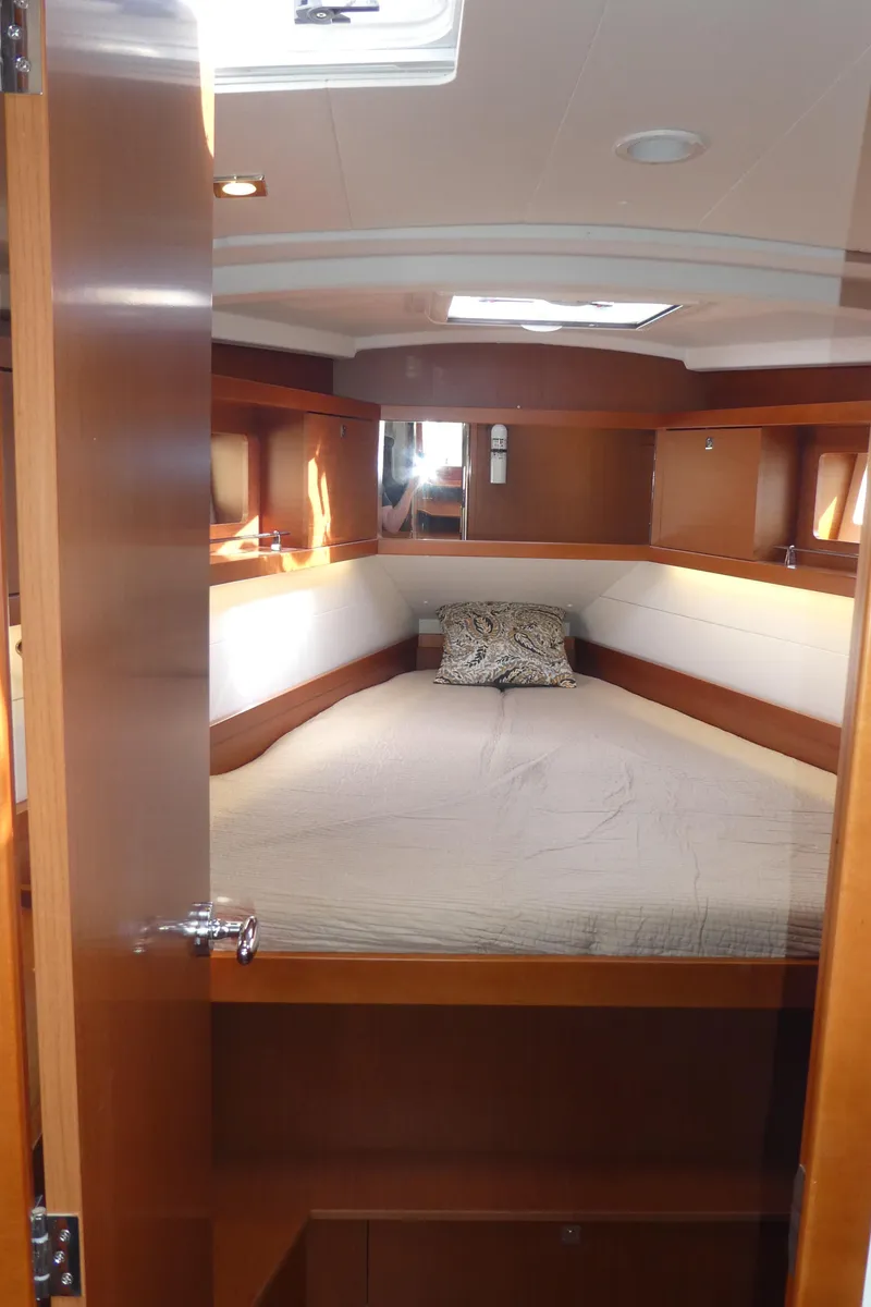 Slide: The Image of 2014 Beneteau Oceanis 41 cabin interior with cozy bed and wooden finish. - 38