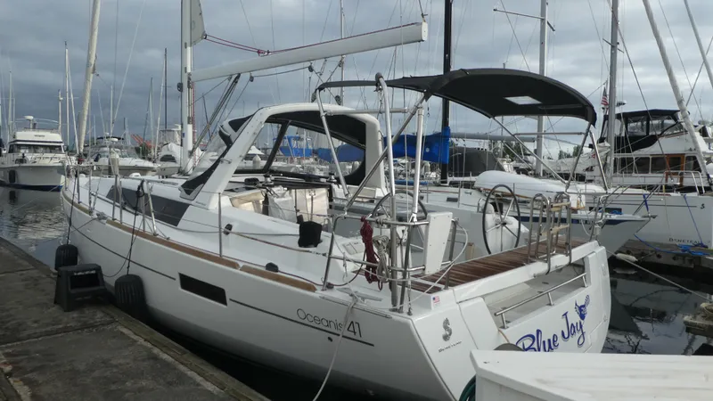 Slide: The Image of 2014 Beneteau Oceanis 41 sailboat docked at marina, overcast sky. - 4