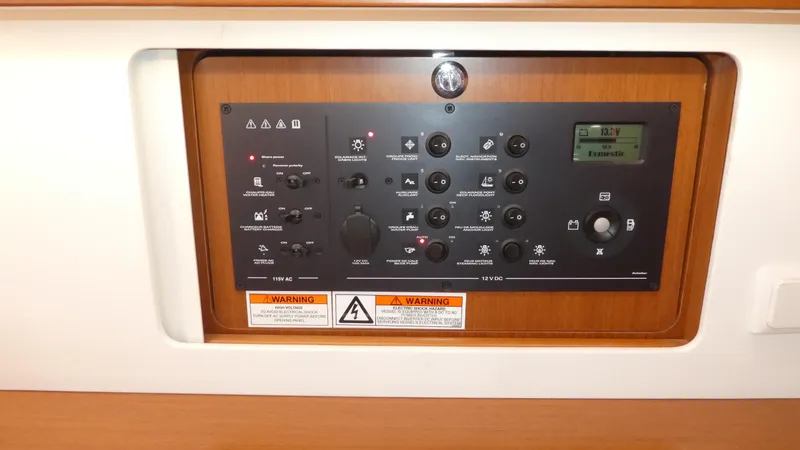 Slide: The Image of Control panel of a 2014 Beneteau Oceanis 41 sailboat, featuring various switches and indicators. - 42
