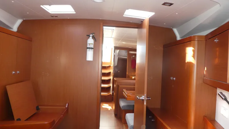 Slide: The Image of Interior of 2014 Beneteau Oceanis 41 sailboat with wooden cabinetry and seating. - 45