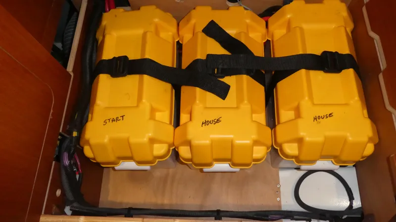 Slide: The Image of Yellow battery boxes labeled "Start" and "House" in a 2014 Beneteau Oceanis 41 sailboat. - 48