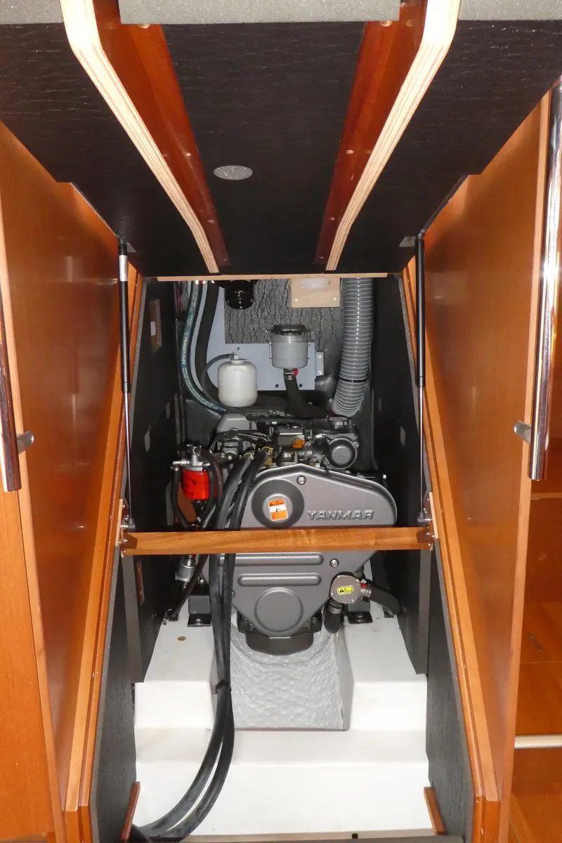 Slide: The Image of 2014 Beneteau Oceanis 41 engine compartment with Yanmar engine, showcasing clean and organized layout. - 49