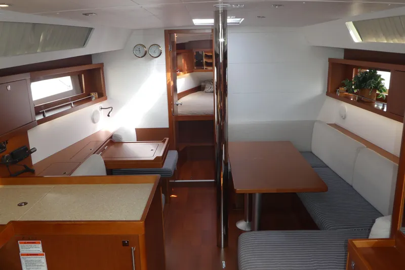 Slide: The Image of Interior of 2014 Beneteau Oceanis 41 sailboat with dining area and cozy seating. - 7