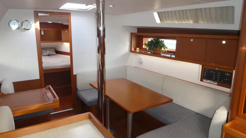 Slide: The Image of Interior of 2014 Beneteau Oceanis 41 sailboat with cozy dining area and cabin. - 8
