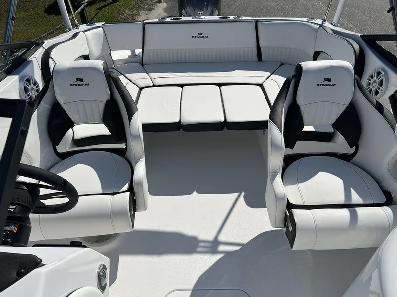 Slide: The Image of 2025 Stingray 211DC boat interior with white seating and black accents. - 12