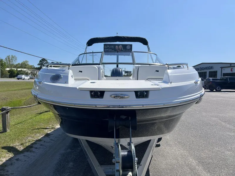 Slide: The Image of 2025 Stingray 211DC boat on trailer, front view, sunny day. - 7