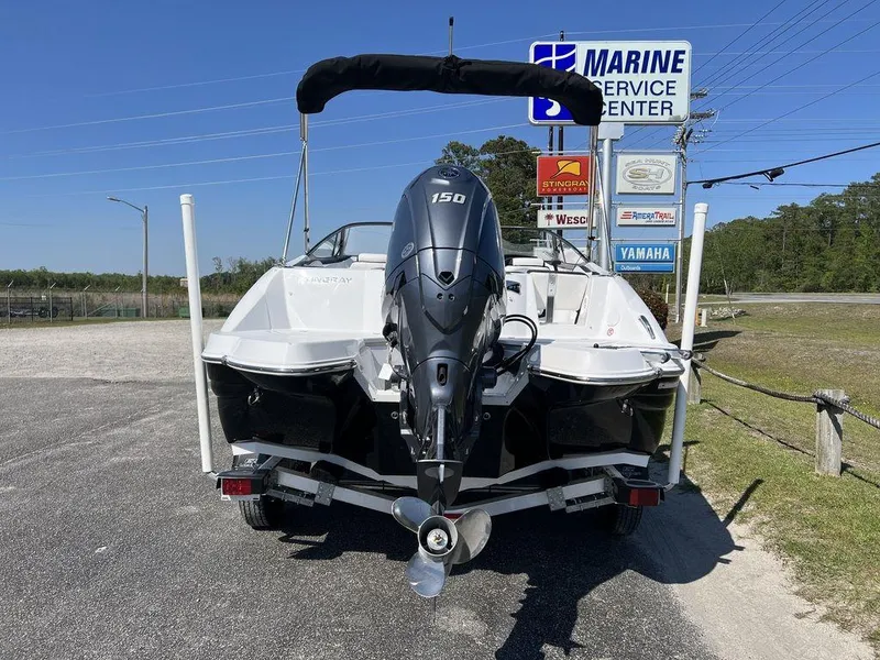 Slide: The Image of 2025 Stingray 211DC boat with outboard motor at marine service center. - 8