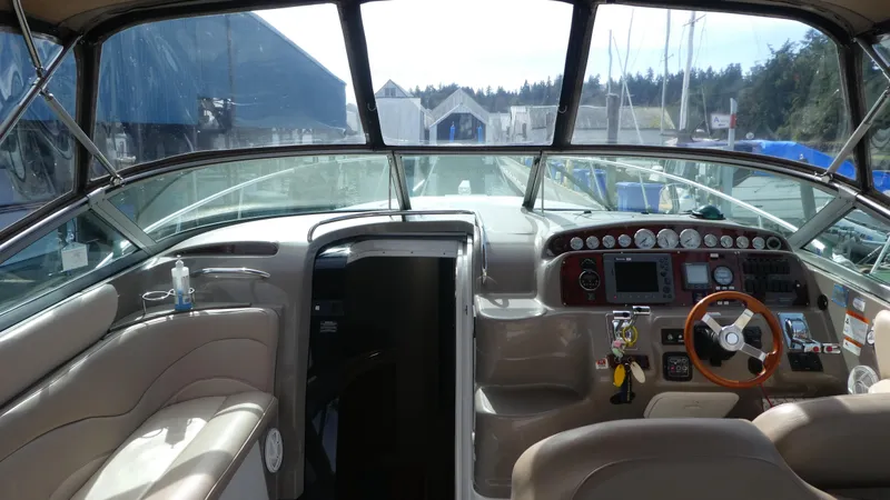 Slide: The Image of Interior view of a 2004 Larson 370 boat cockpit with steering wheel and control panel. - 14