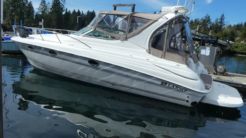 Slide: The Image of 2004 Larson 370 boat docked in a serene marina setting. - 2