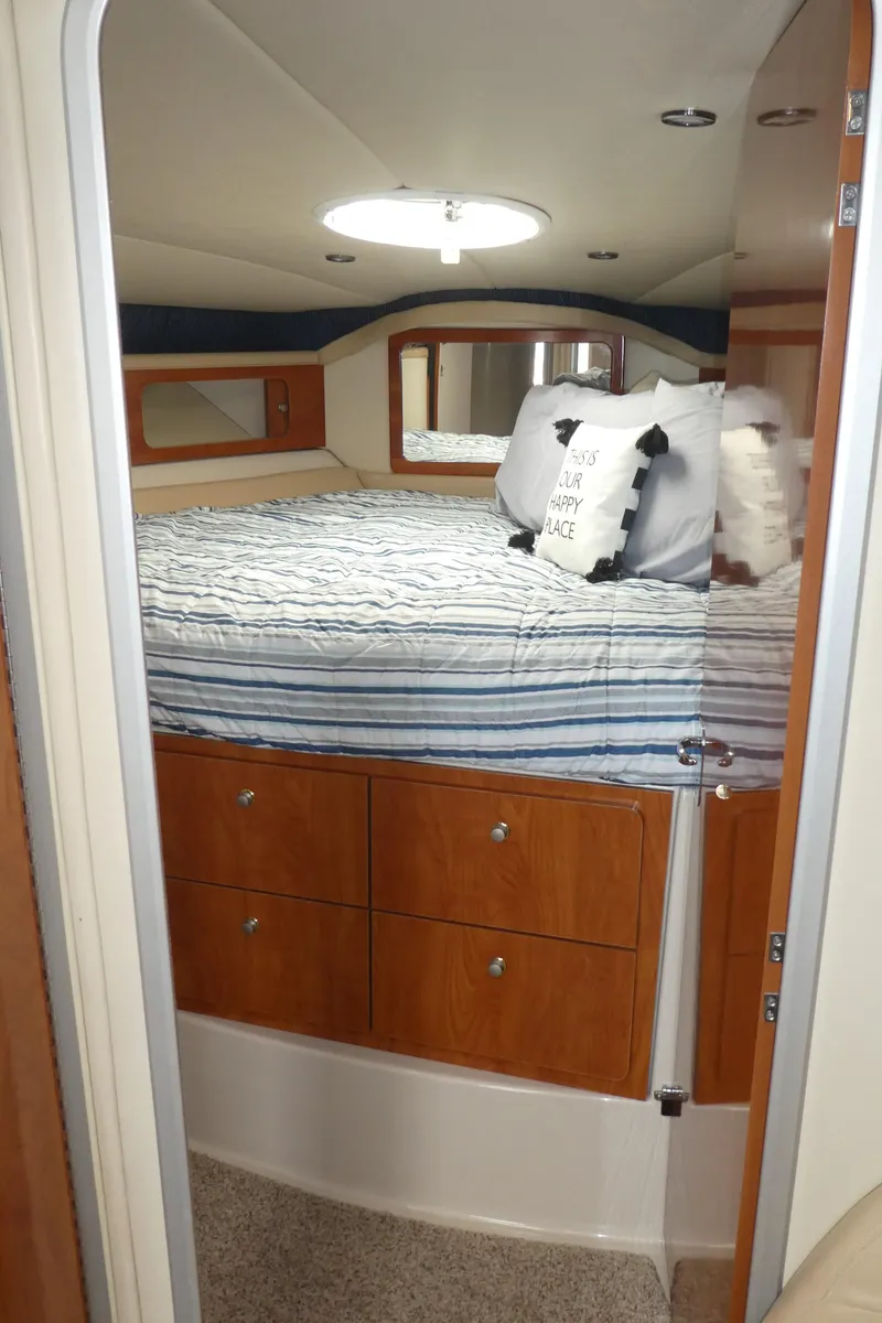 Slide: The Image of Cozy cabin interior of a 2004 Larson 370 boat with a neatly made bed. - 23