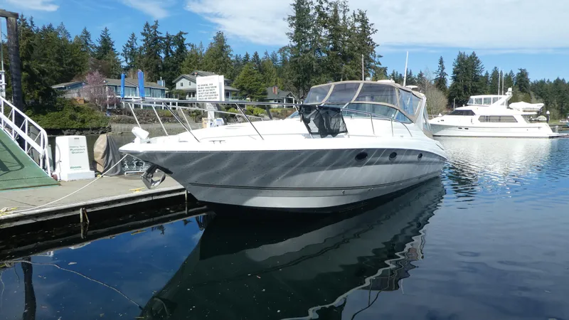 Slide: The Image of 2004 Larson 370 boat docked in a serene marina setting. - 3