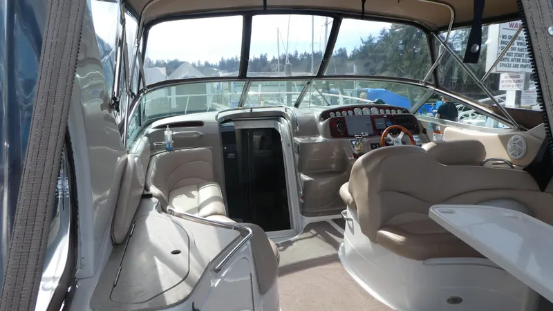 Slide: The Image of Interior view of a 2004 Larson 370 boat, featuring seating and control panel. - 5