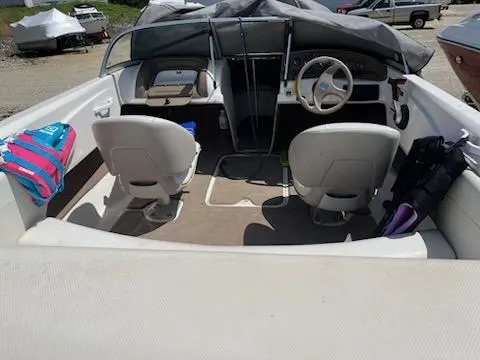 Slide: The Image of 2006 Larson 180 Bowrider SEI interior with covered dashboard and seating. - 3