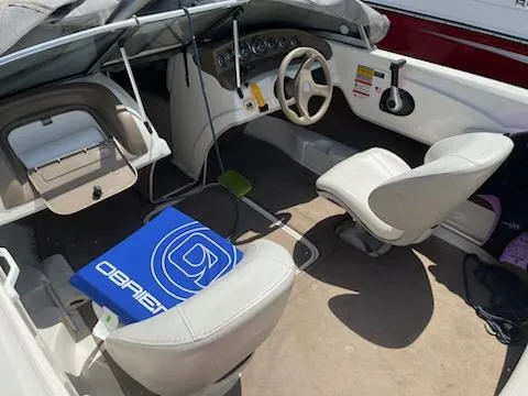 Slide: The Image of Interior of a 2006 Larson 180 Bowrider SEI boat with white seating and dashboard. - 6