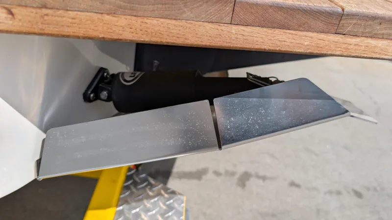 Slide: The Image of 2013 MasterCraft X2 boat trim tab detail with wooden deck. - 11