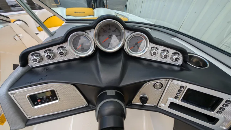 Slide: The Image of Dashboard of a 2013 MasterCraft X2 boat with gauges and controls. - 13