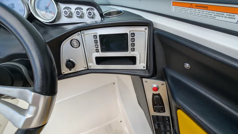 Slide: The Image of Dashboard of a 2013 MasterCraft X2 boat with steering wheel and control panel. - 15