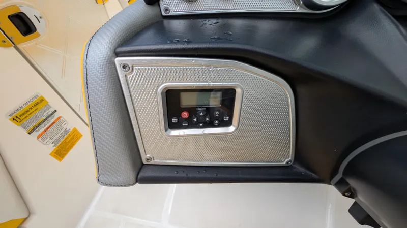 Slide: The Image of Control panel of a 2013 MasterCraft X2 boat, featuring a digital display and buttons. - 16