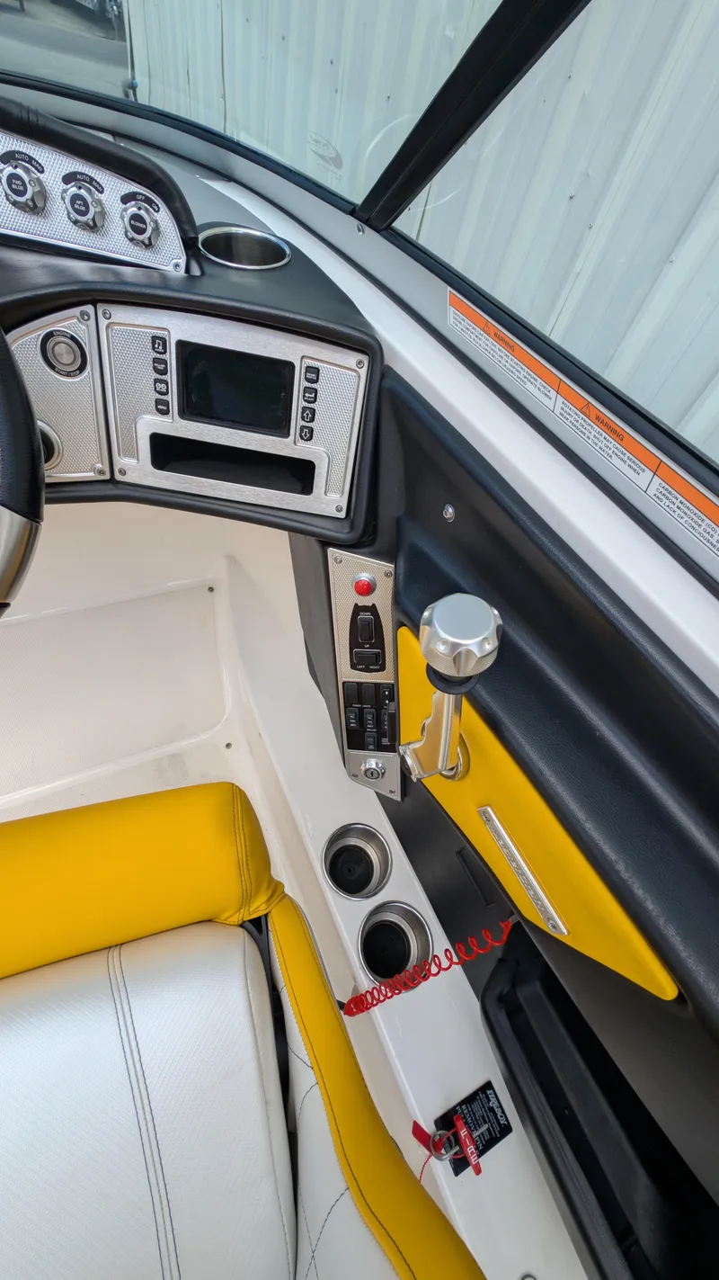 Slide: The Image of 2013 MasterCraft X2 boat interior with yellow seating and control panel. - 17