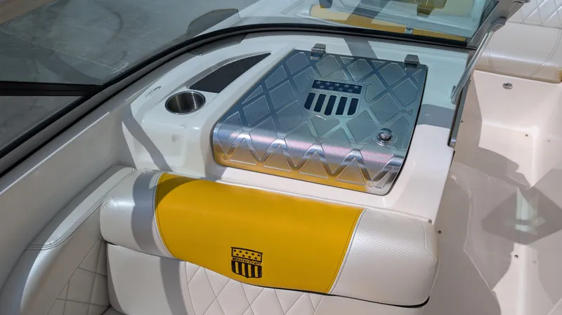 Slide: The Image of 2013 MasterCraft X2 boat interior with yellow and white seating, diamond-patterned metal cover. - 20