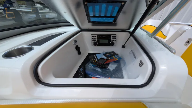 Slide: The Image of 2013 MasterCraft X2 boat storage compartment with stereo system and accessories. - 21