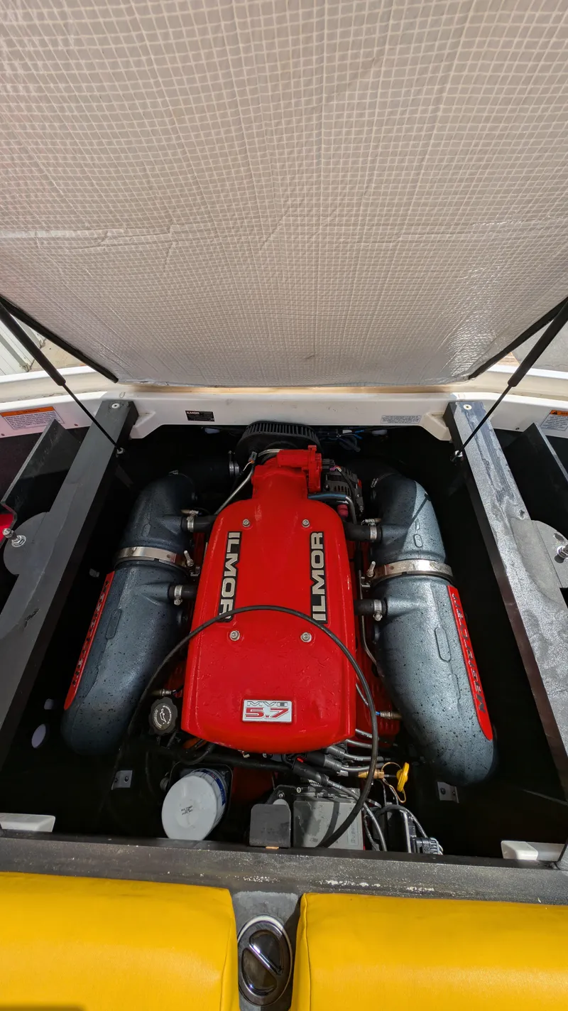 Slide: The Image of 2013 MasterCraft X2 boat engine with red Ilmor cover, open compartment view. - 22