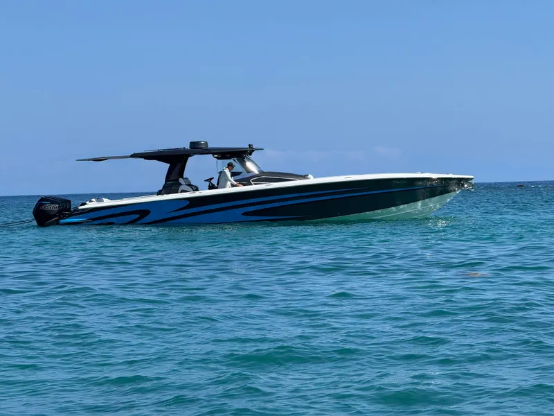 Slide: The Image of 2022 Nor-Tech 450 Sport Center Console boat on clear blue water. - 1