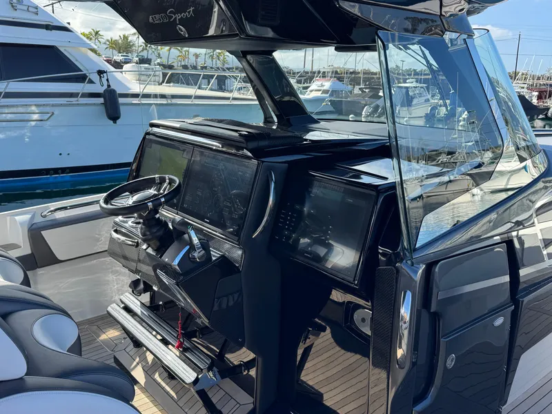 Slide: The Image of 2022 Nor-Tech 450 Sport Center Console boat interior with modern dashboard and steering wheel. - 11