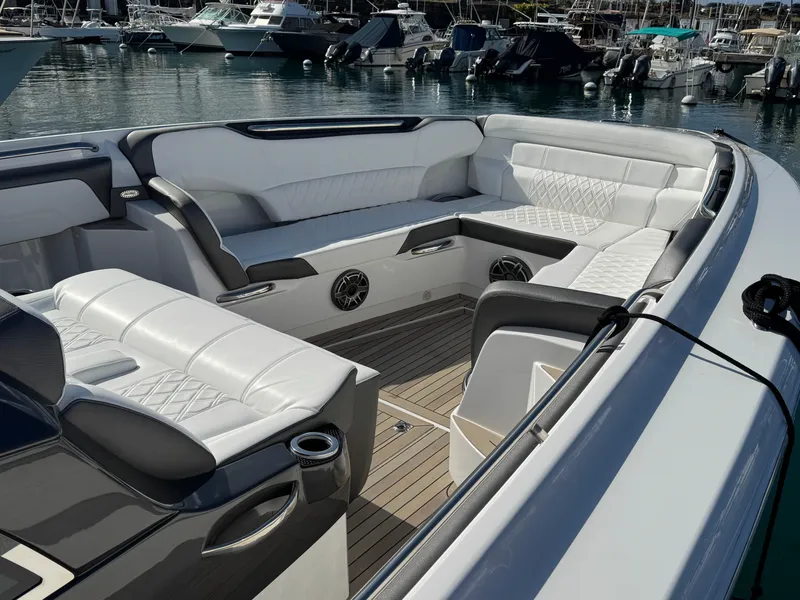 Slide: The Image of 2022 Nor-Tech 450 Sport Center Console with luxurious seating in a marina setting. - 12