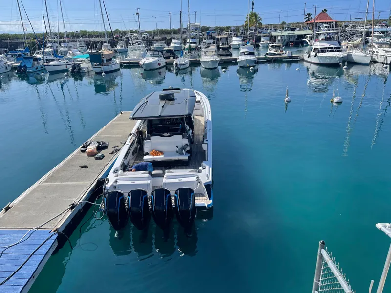 Slide: The Image of 2022 Nor-Tech 450 Sport Center Console docked in a marina with multiple boats. - 16