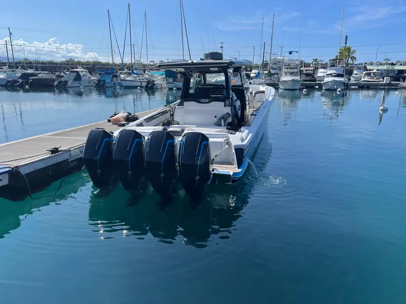 Slide: The Image of 2022 Nor-Tech 450 Sport Center Console boat docked in a marina. - 18