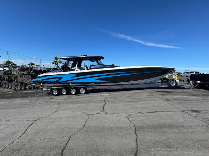 Slide: The Image of 2022 Nor-Tech 450 Sport Center Console boat on trailer, blue and white design. - 20