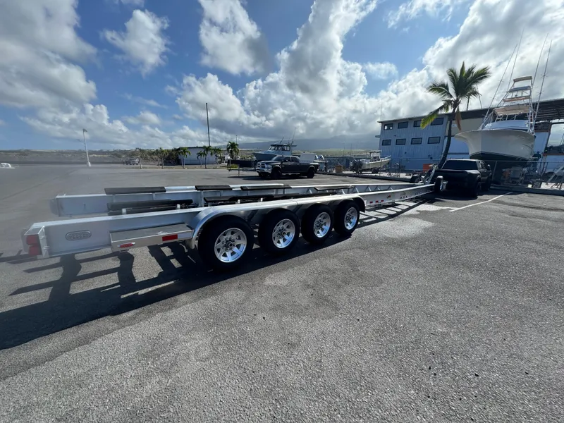 Slide: The Image of Trailer for 2022 Nor-Tech 450 Sport Center Console at marina with palm trees. - 25