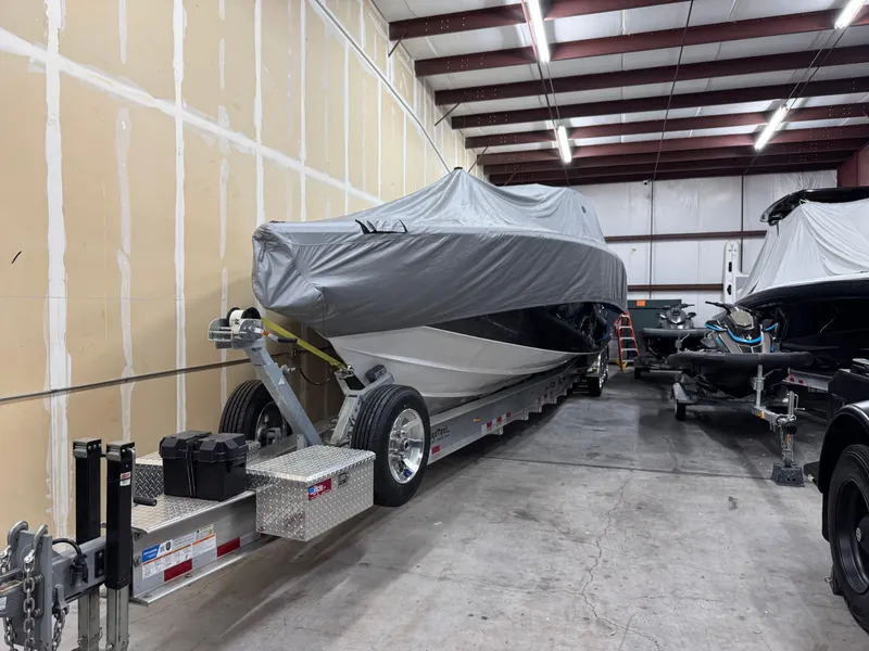 Slide: The Image of 2022 Nor-Tech 450 Sport Center Console boat covered in storage facility. - 28