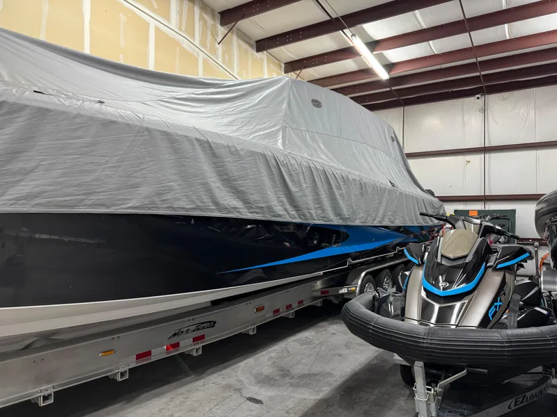 Slide: The Image of 2022 Nor-Tech 450 Sport Center Console boat covered in storage facility. - 29