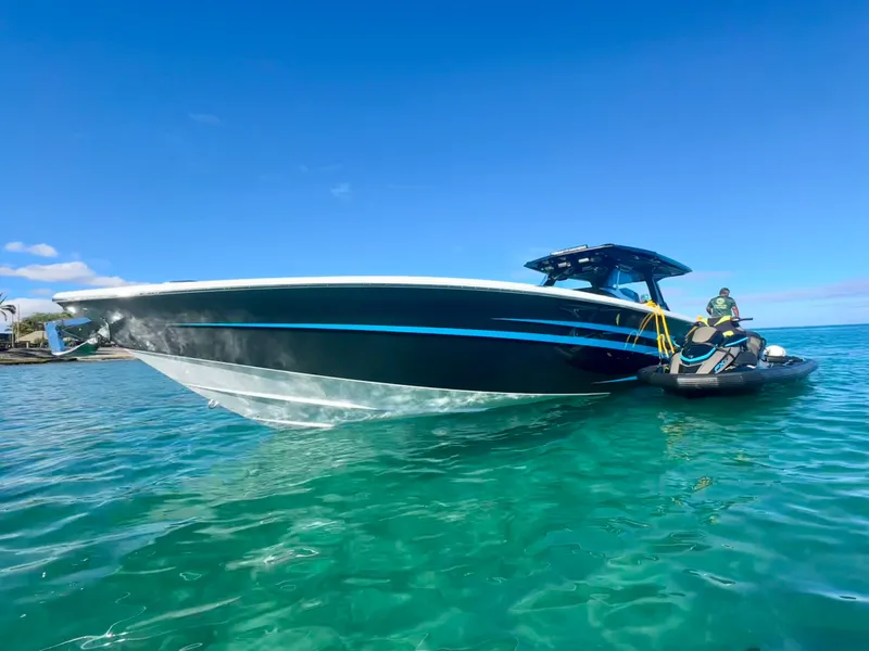 Slide: The Image of 2022 Nor-Tech 450 Sport Center Console boat on clear turquoise water under blue sky. - 3
