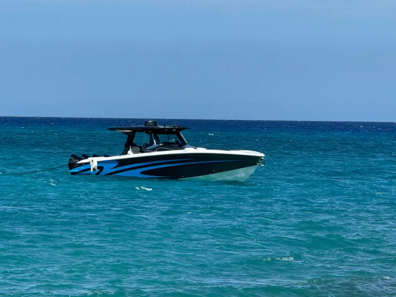 Slide: The Image of 2022 Nor-Tech 450 Sport Center Console boat on clear blue ocean water. - 4