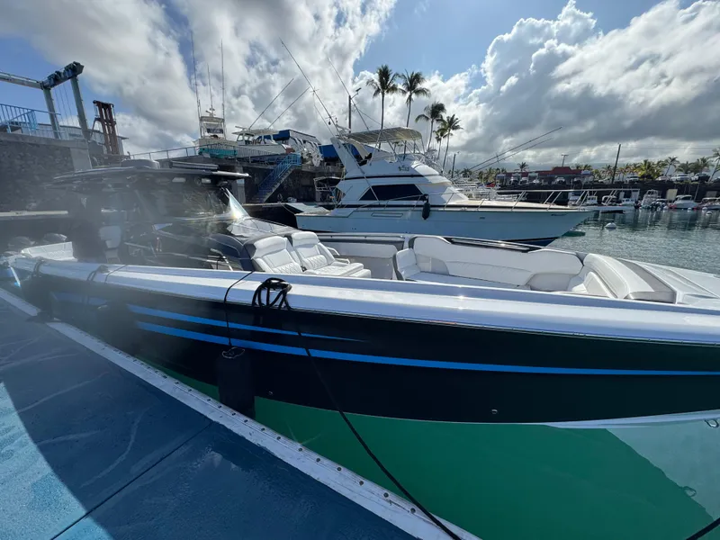 Slide: The Image of 2022 Nor-Tech 450 Sport Center Console docked at a marina under a cloudy sky. - 5