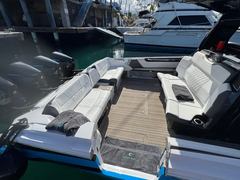Slide: The Image of 2022 Nor-Tech 450 Sport Center Console with spacious seating and sleek design in a marina. - 9