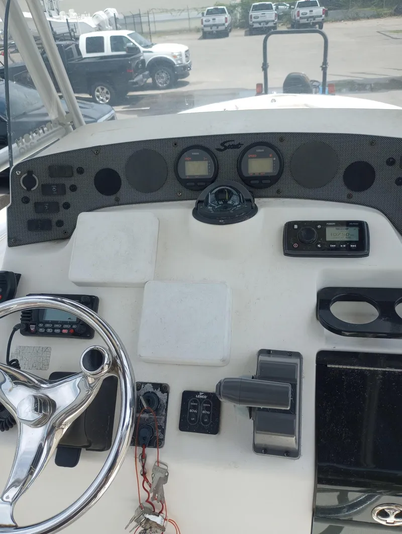Slide: The Image of 2005 Scout 205 Sportfish boat interior with brown and beige seating. - 11