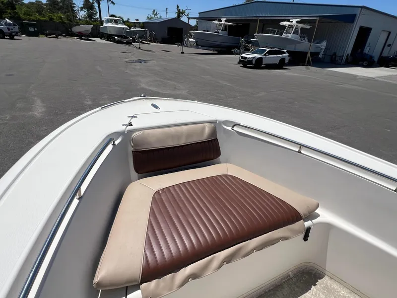 Slide: The Image of 2005 Scout 205 Sportfish boat on trailer, parked outdoors under clear blue sky. - 3