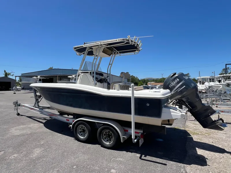 Slide: The Image of 2005 Scout 205 Sportfish boat with Yamaha outboard motor, parked outdoors. - 4