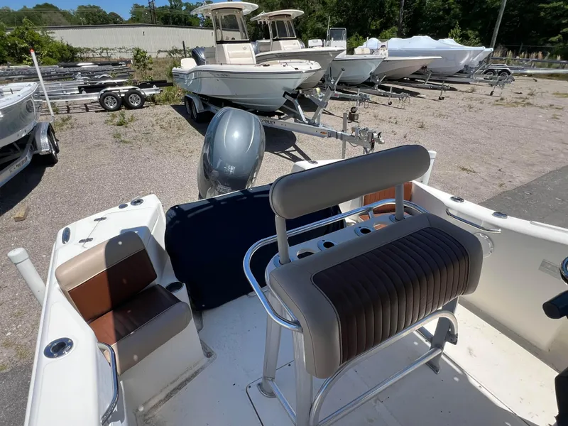 Slide: The Image of 2005 Scout 205 Sportfish boat on trailer, featuring Yamaha outboard motor, parked outdoors. - 6