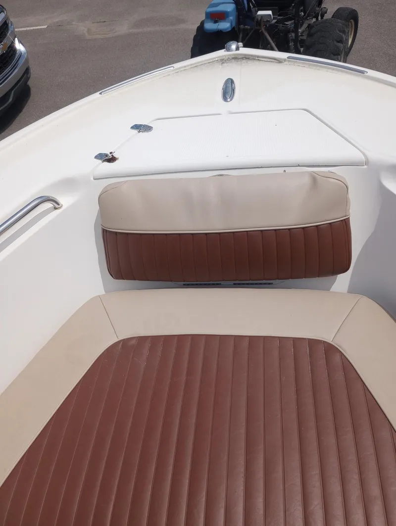 Slide: The Image of 2005 Scout 205 Sportfish boat with T-top, docked under clear blue sky. - 7