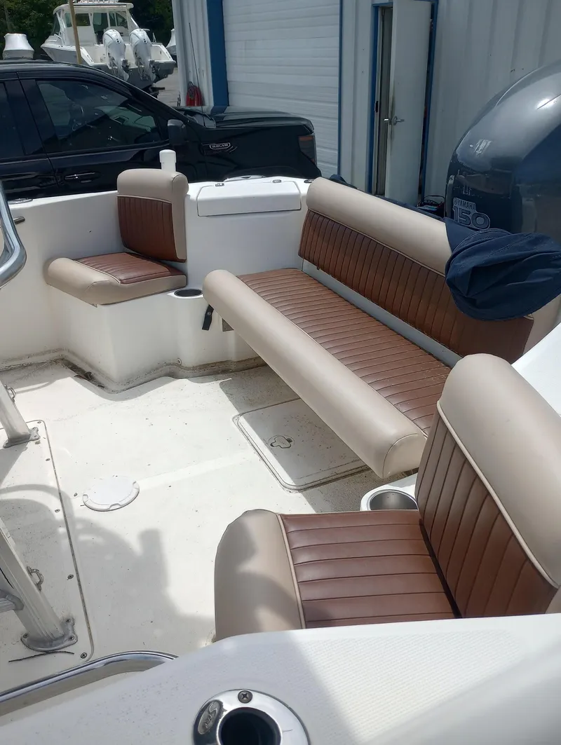 Slide: The Image of 2005 Scout 205 Sportfish boat interior with brown and beige seating. - 9