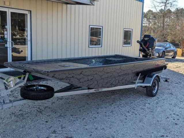 Slide: The Image of 2025 Gator Tail 1754 Extreme Series boat on trailer outside a building. - 2