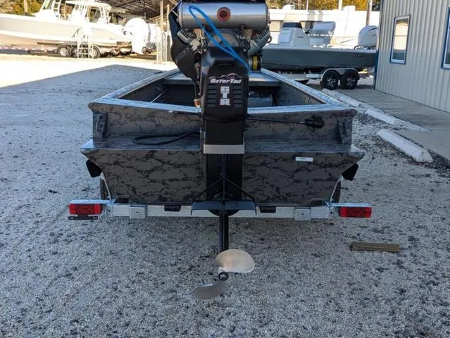 Slide: The Image of 2025 Gator Tail 1754 Extreme Series boat with motor, parked on gravel. - 6