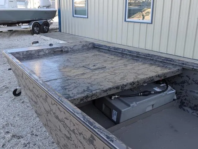 Slide: The Image of 2025 Gator Tail 1754 Extreme Series boat with camouflage design, parked near a building. - 9