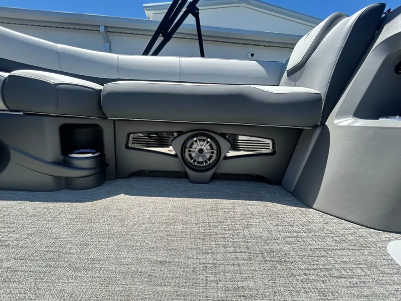 Slide: The Image of 2025 Tahoe LTZ QL25T boat interior with gray seating and integrated speaker system. - 11